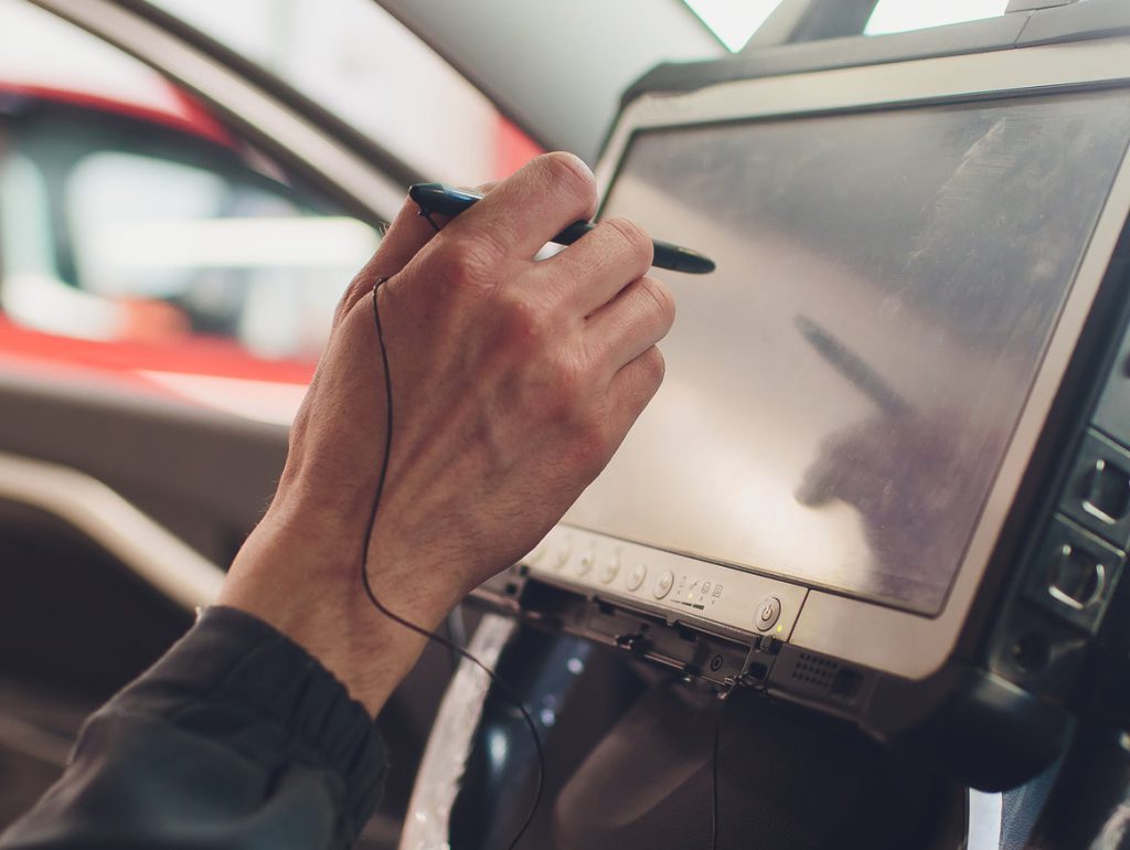 Mechanic pointing at a diagnostics computer - Car Diagnostics Colwyn Bay